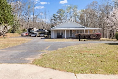 View of front of home with aphalt driveway, a carp