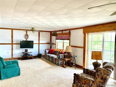 Large living room with sliding glass door to deck