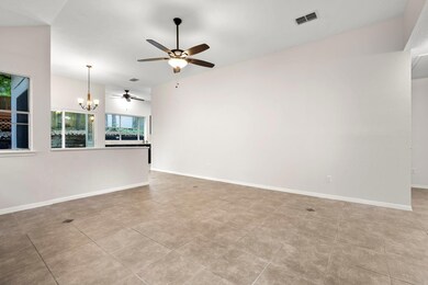 Unfurnished living room with ceiling fan, a chand