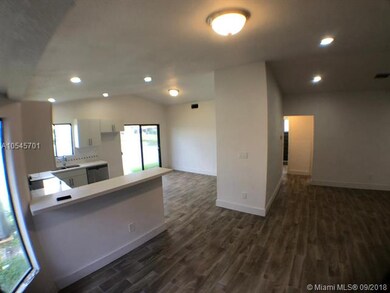 Living area looking into kitchen. Lots of windows!