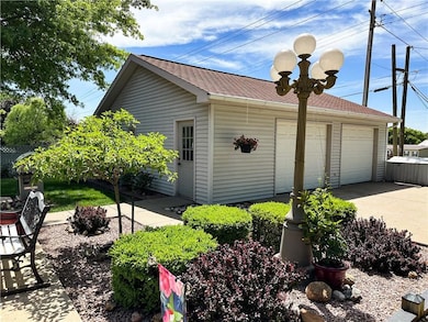 View of home's exterior featuring an outbuilding, a garage, and a shingled roof