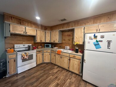 Kitchen featuring a sink, white appliances, visibl