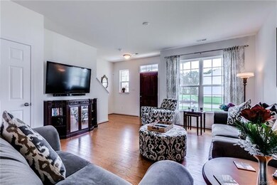 Family room has hardwood floors and oversized wind