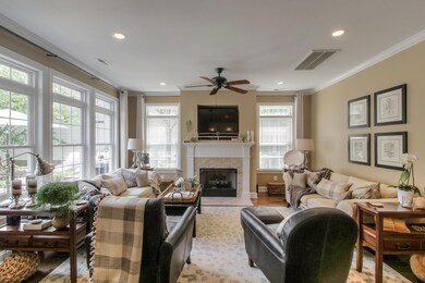 Inviting and filled with light, the living room overlooks the courtyard and is adjoined by the kitchen.