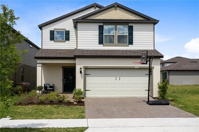 FRONT OF THE HOUSE WITH BRICK PAVERS ON DRIVEWAY A