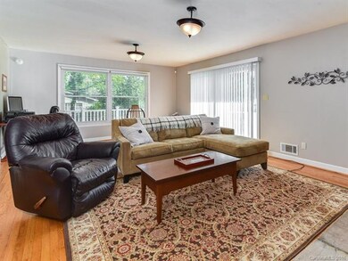 Patio doors lead out onto front porch.
