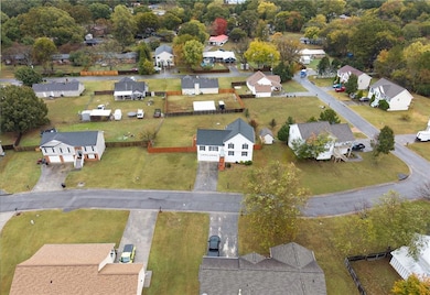 Aerial overview of property's location featuring nearby suburban area