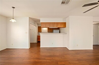 Kitchen with brown cabinets, a ceiling fan, wood 