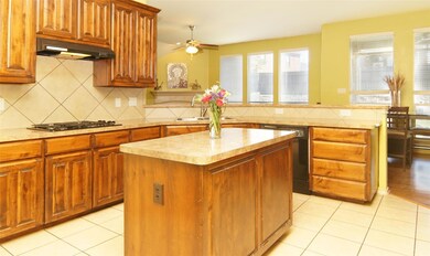 Kitchen featuring a 4-foot center island, gas cook