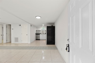 One unit features tile flooring and an open-concept living and kitchen area—low maintenance and tenant-friendly.