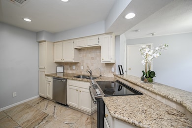 This kitchen features elegant granite countertops,