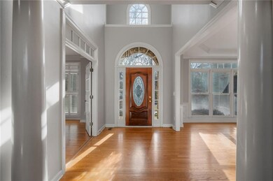 Foyer featuring baseboards, a high ceiling, and li