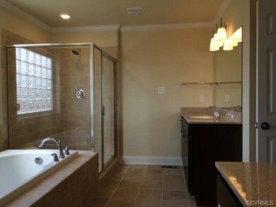 Owners suite bathroom with ceramic tile and separa