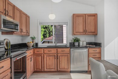 The gourmet kitchen features quartz countertops, stainless steel appliances & more!