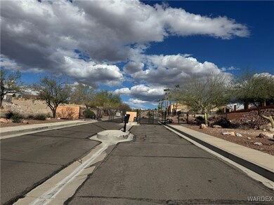 View of gate entrance with curbs and sidewalks