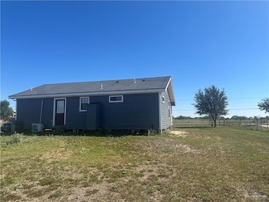 Rear view of house with roof with shingles
