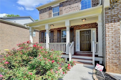 Property entrance with brick siding and covered po