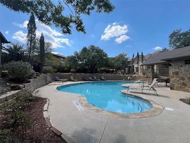 Community pool with a patio and a residential view