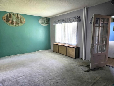 Unfurnished room featuring a textured ceiling and 