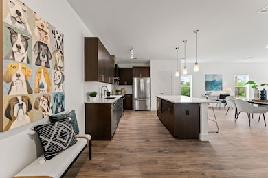 Kitchen with a breakfast bar area, a sink, dark b