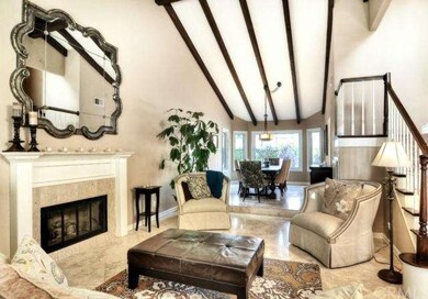 Formal living room with dark wood beamed ceilings,