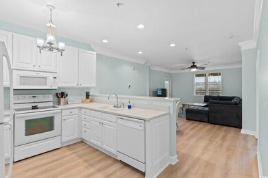 Kitchen with pendant lighting, white appliances, k