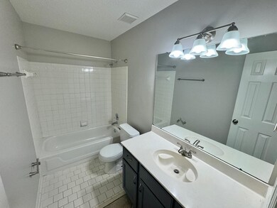 Full bathroom featuring tile patterned flooring, t