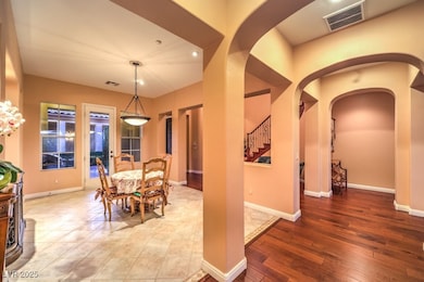 Dining room with arched walkways, wood finished fl