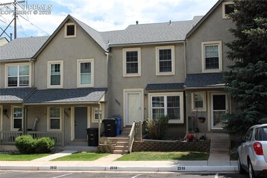 Multi unit property with roof with shingles, stucco siding, and covered porch