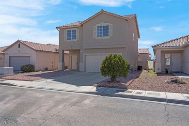 View of front of home with concrete driveway, a ti