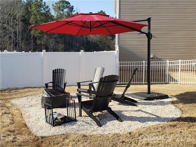 Firepit area in the fenced rear yard