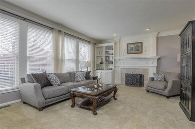 Wall of windows in great room with builtins and ga