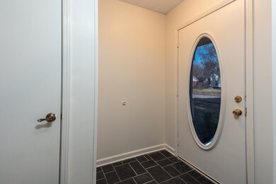 Entryway featuring baseboards and a textured ceili