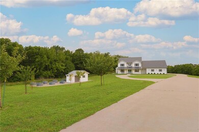 View of grassy yard and garden with an outbuilding.  Perfect she/he shed!