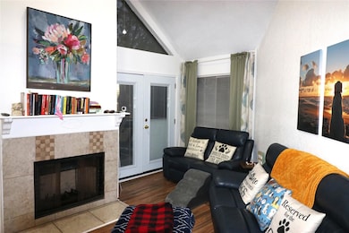 Living room featuring lofted ceiling, a fireplace,