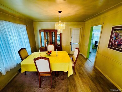 Dining space featuring plenty of natural light, wood finished floors, and a chandelier
