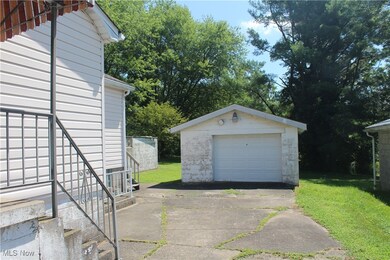 Detached garage featuring concrete driveway