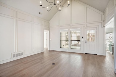 Unfurnished living room featuring visible vents, h