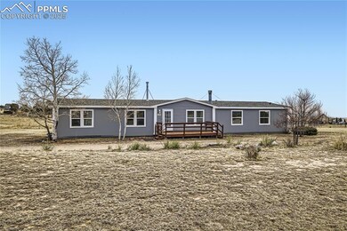 View of front of property with a wooden deck