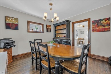 Dining area with a chandelier and dark hardwood / wood-style floors