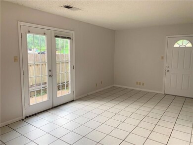 Foyer with baseboards, french doors, visible vent