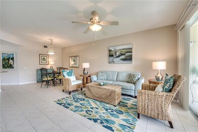 Living room featuring a ceiling fan, visible vents
