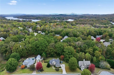 Aerial view of a heavily wooded area and a water and mountain view