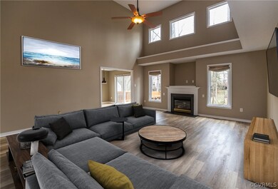 Vaulted family room with laminate flooring, large