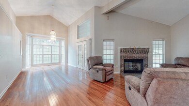 This large Living Room is made to feel so open with the soaring ceilings and new hardwood flooring!