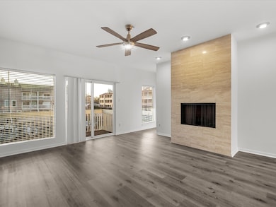 Living Room with Tiled Fireplace and Water Views