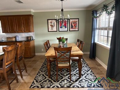 Dining space featuring a chandelier and ornamental molding