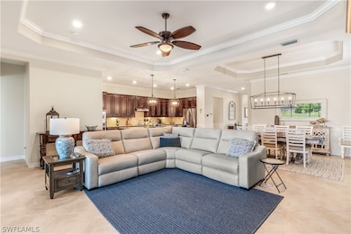 Tiled living room with ceiling fan with notable ch