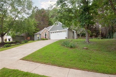 View of front facade featuring a front lawn, concr