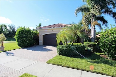 View of side of property featuring a yard and a garage